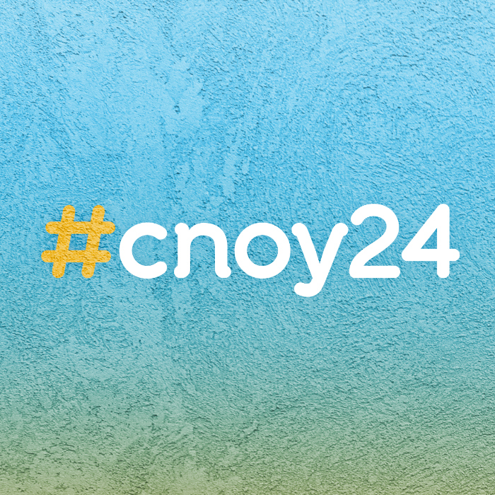 An image with background that looks like ice and is light blue variegated to green and yellow. The text hashtag #cnoy24 appears in the center of the image.